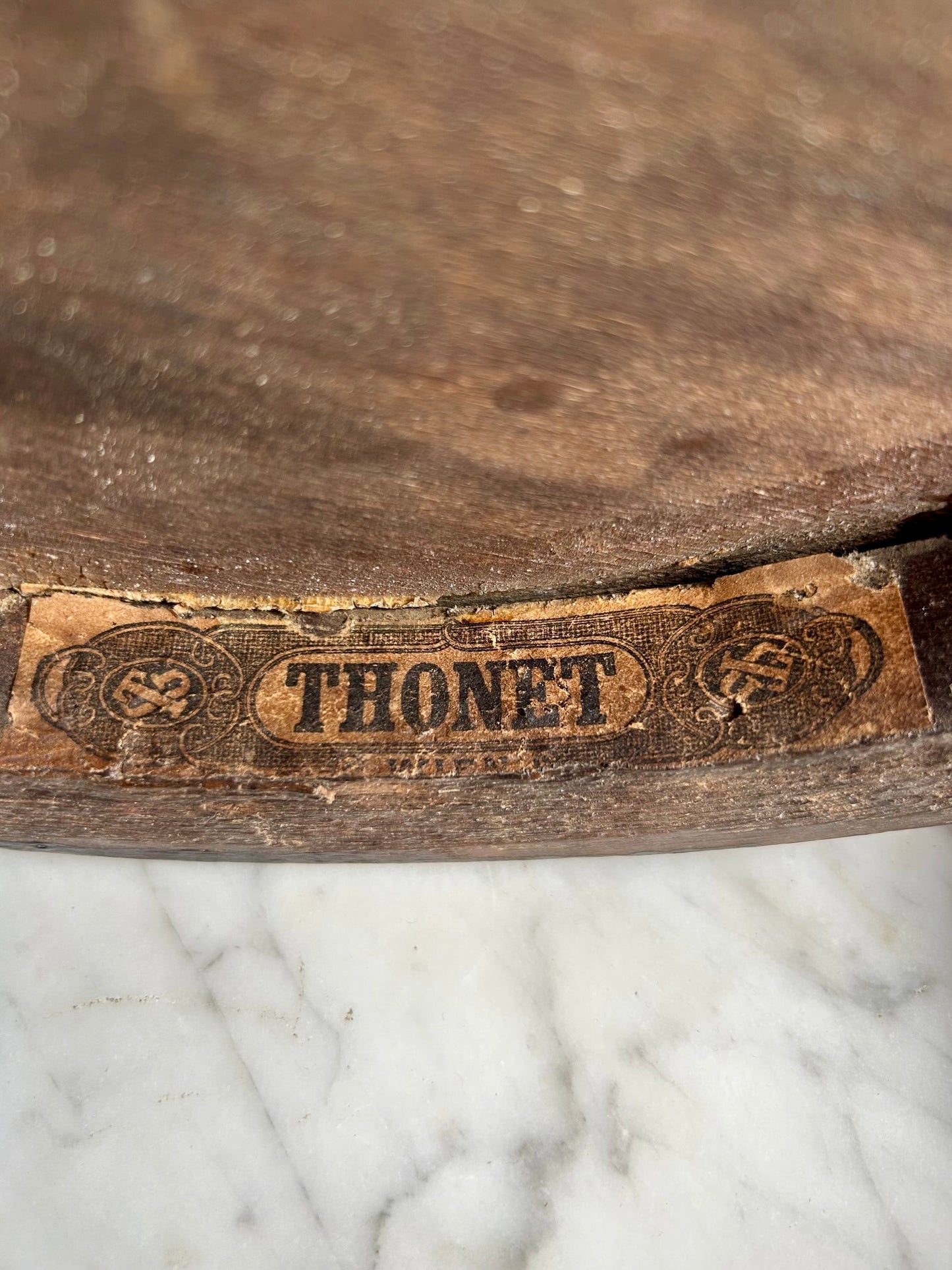 Wooden surface with 'Thonet' branding on a paper background